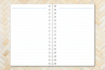 Open notebook paper with line on bamboo weave background for design with copy space for text or image.