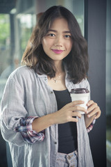 asian woman and hot coffee cup in hand relaxing emotion smiling