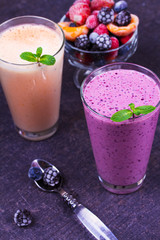 Frozen summer berries smoothie with mint. Raspberry, strawberry, dogwood, blackberry, blueberry, apricot and banana drink.