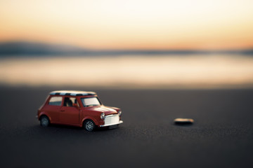Mini cooper toy car on the beach - obrazy, fototapety, plakaty