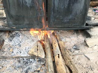 kindle fire for boil bamboo shoot in BUCKET PAIL