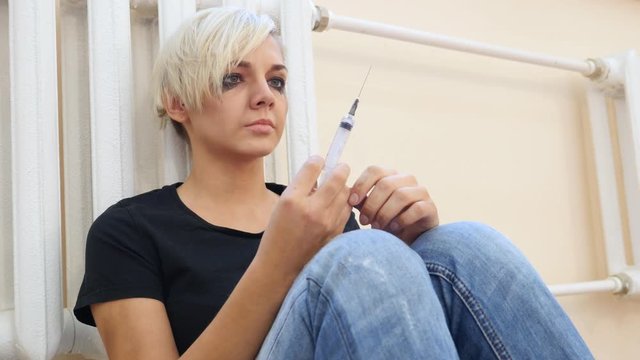 Face of Young Girl Holding Syringe