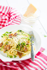 Pasta carbonara. Spaghetti with bacon and parmesan cheese greens