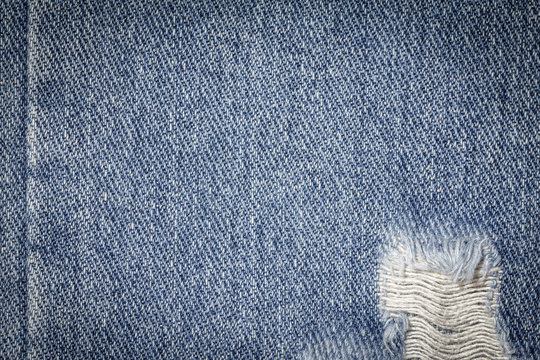 Denim jeans texture or denim jeans background with seam and old torn. Old grunge vintage denim jeans. Stitched texture denim jeans background of jeans fashion design.