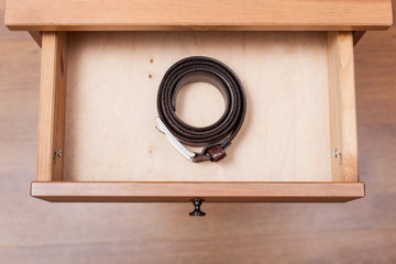 leather belt in open drawer