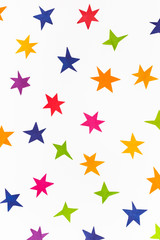 various stars cut out from colored paper on white