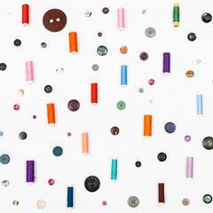 many spools of sewing thread and various buttons