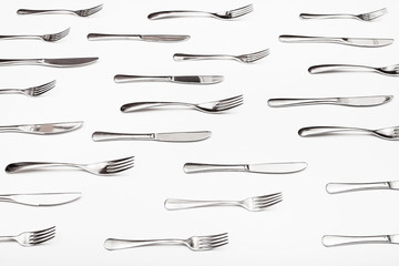 side view of many table knives and forks