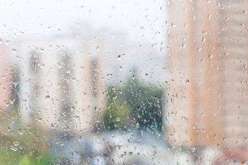 view of wet window glass of urban house