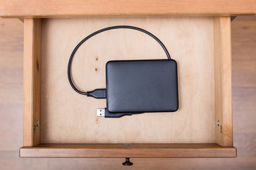 external computer hard drive in open drawer