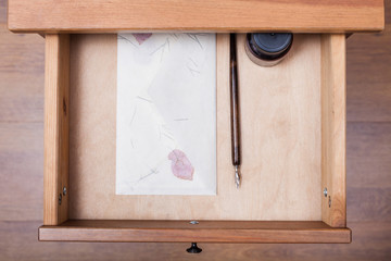 nib pen, ink, vintage envelope in open drawer