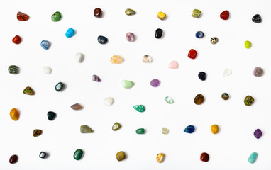 many semi-precious stones arranged on white