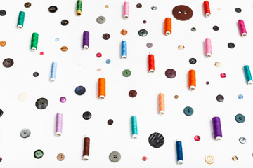 side view of spools of thread and various buttons