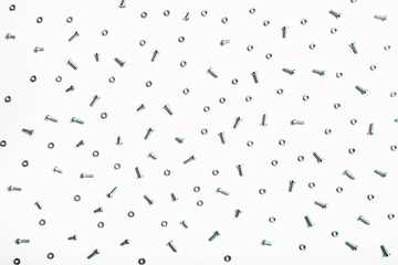 many steel bolts and nuts on white
