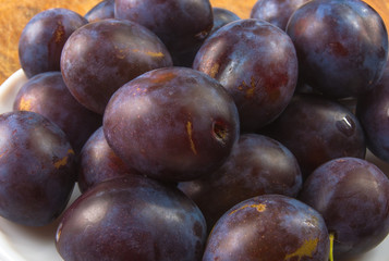 small plums on a white saucer