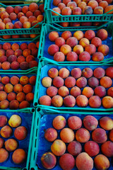 Fresh ripe peaches in boxes in whole sale market