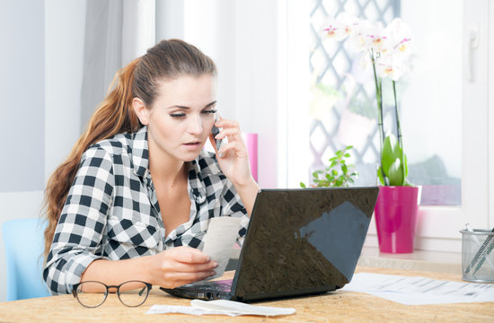 Young woman working in home office using laptop