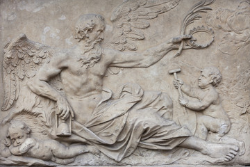 Sculpture of an old angel blessing a child 