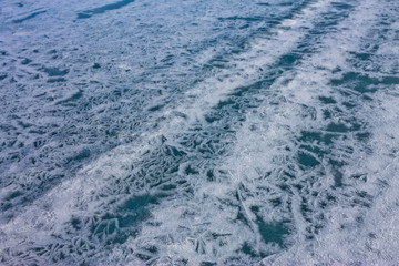 Traces of wheels on the cracked ice of Lake Baikal
