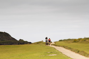 Cyclists on a costal path in Cornwall