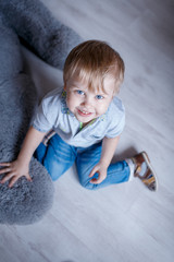 Fototapeta premium Portrait of little boy with a big toy bear in the Studio posing emotions