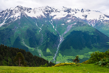 Mountain summer landscape with meadow, forest and mountain panorama. Svaneti region of Georgia