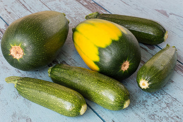 Zucchini.   Young freshly picked zucchini on a blue wooden background.