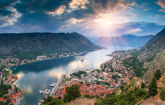 Panoramic landscape Kotor bay in Montenegro at sunset. Dramatic evening light. Balkans, Adriatic sea, Europe. View from the top of the mountain.