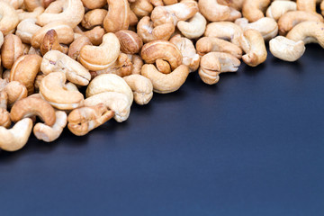 Roasted cashew nuts on black plate