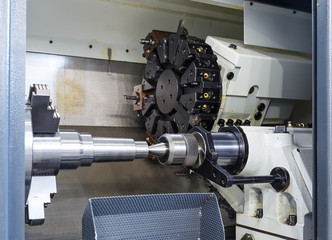 Rotating head with drilling machine bits and tools in a high precision mechanics plant at CNC lathe...