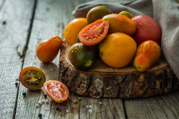 Selection of colorful tomatoes on rustic wood background