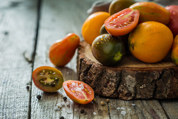Selection of colorful tomatoes on rustic wood background