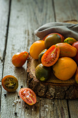 Selection of colorful tomatoes on rustic wood background