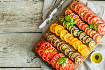 Selection of sliced colorful tomatoes on wood board