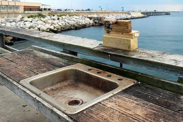 A public fish cleaning station on the pier at the Chesapeake Bay Bridge-Tunnel, Virginia Beach, USA