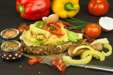 Fresh scrambled eggs on sunflower bread. Healthy food . Domestic food preparation. Eggs for a snack. Diet food. Toasted bread with scrambled eggs.
