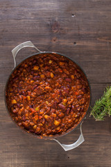 Organic Vegetarian Chili In Iron Pot Served With Rosemary On Dis