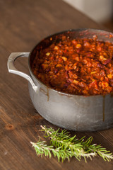 Organic Vegetarian Chili In Iron Pot Served With Rosemary On Dis