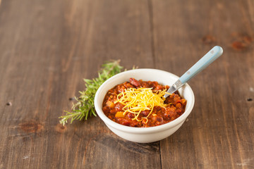 A Hot Bowl Of Spicy Organic Vegetarian Chili With Melted Cheese