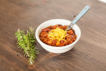 A Hot Bowl Of Spicy Organic Vegetarian Chili With Melted Cheese