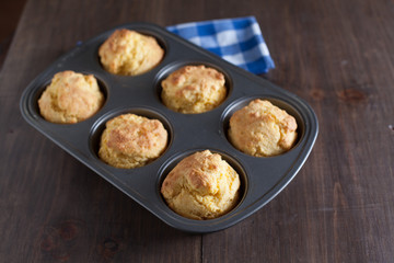 Corn Bread Muffins In Muffin Pan On Country Distressed Wood Tabl