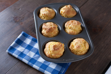 Corn Bread Muffins In Muffin Pan On Country Distressed Wood Tabl