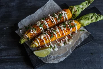 Foto auf Glas mexican grilled corn, elote, dark photo © fazeful