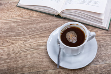 Fototapeta na wymiar A cup of coffee with a book