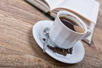A cup of coffee with a book