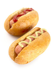 Hotdogs with mustard and ketchup isolated on white from above