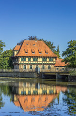Obraz premium Watermill building with reflection in the water in Steinfurt