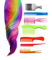 Shiny colorful hair and different combs on white background