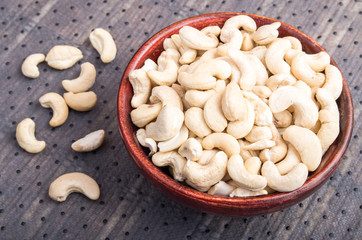 Tasty and healthy raw cashew nuts in a brown bowl