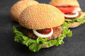 Tasty hamburgers on table